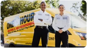 Lakeland One Hour Air Conditioning Techs Greg and Kate in front of a yellow service van