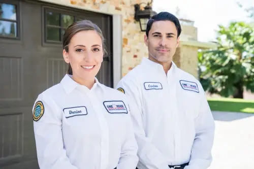 One Hour Air Conditioning Techs, Denise and Carlos, standing in front of home in Lakeland, FL