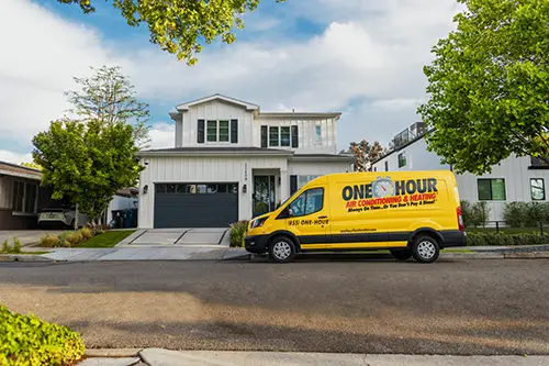 Wide view of a One Hour Air Conditioning Van parked outside a home in Lakeland, FL