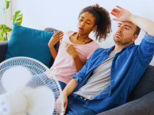 Young couple dealing with room in their home that is hotter than others
