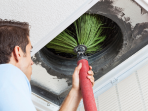 Ductwork cleaning being done by HVAC tech to increase HVAC efficiency